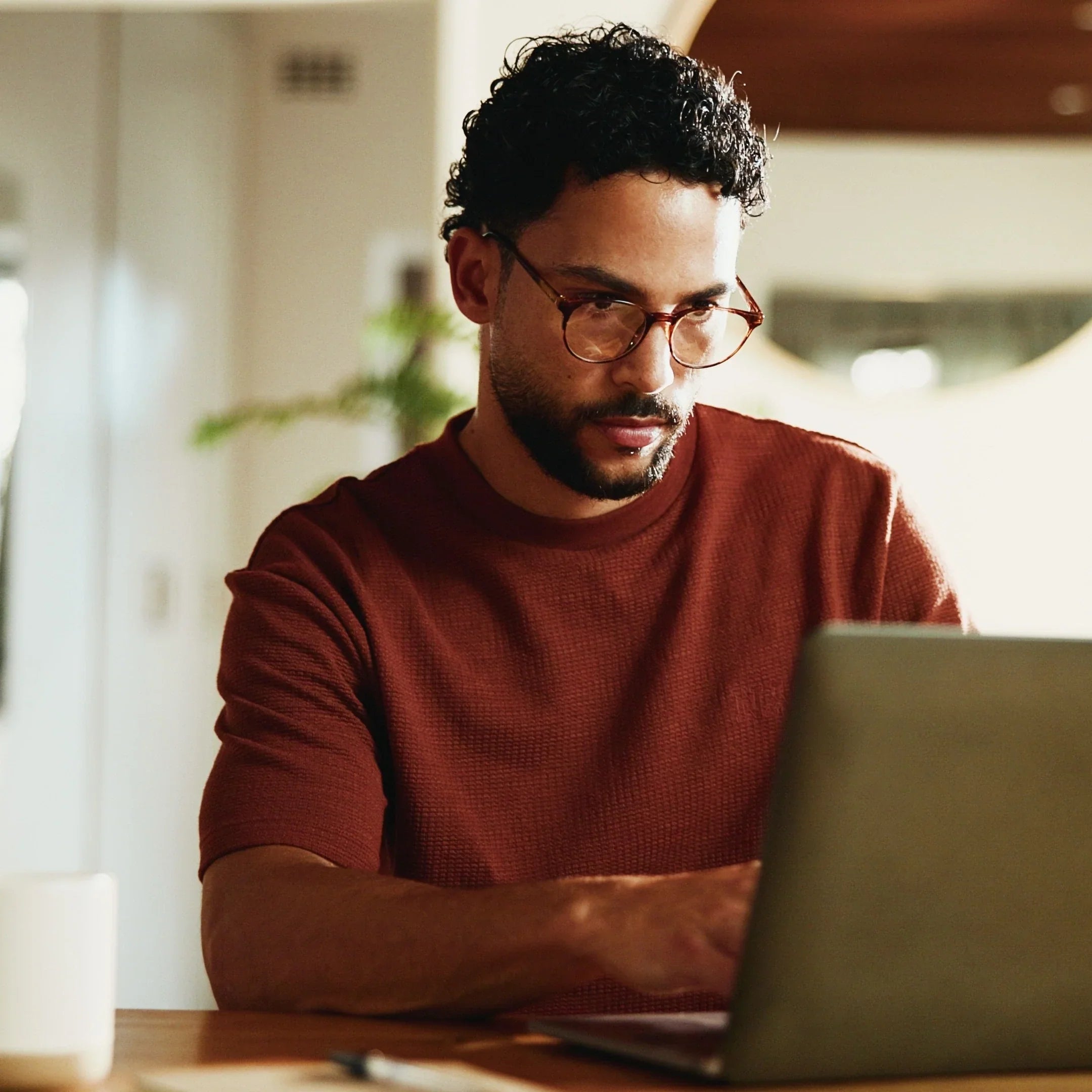 Person working alone and focused on a laptop, with no one else on the call.