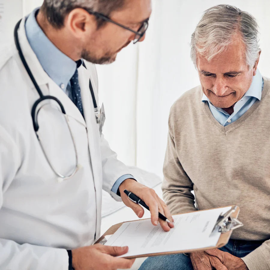 A doctor discussing paperwork with a patient during a medical appointment, highlighting hipaa compliant ai medical transcription.