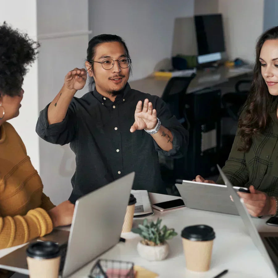 Team collaborating in a meeting, capturing insights with a Plaud AI voice recorder.