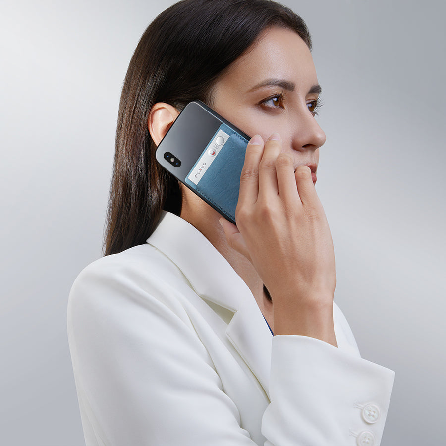 Woman using a smartphone, showing the device's back with an attachment