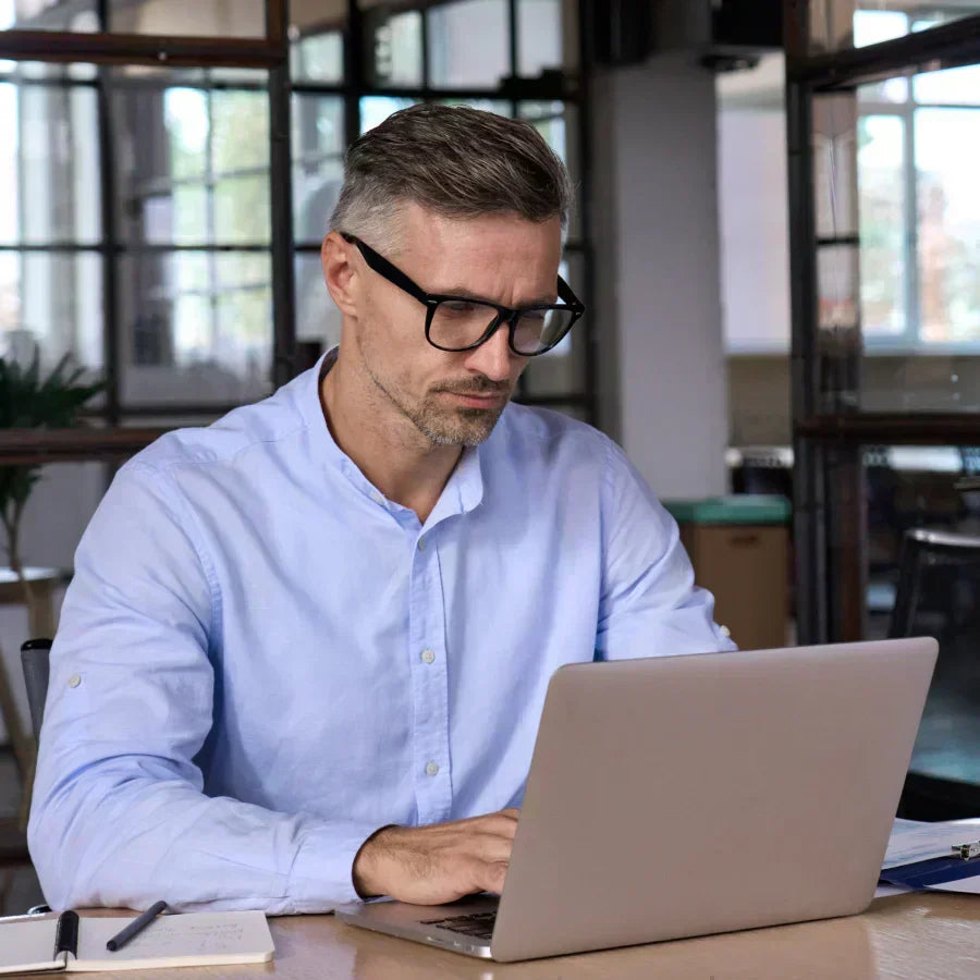 Professional working with Plaud in a modern office.