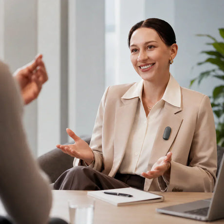 Woman wearing a blazer using a notepad during a meeting