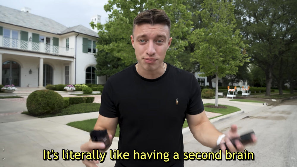 School of hard knocks holds a black Plaud Note with the text "It's literally like having a second brain."