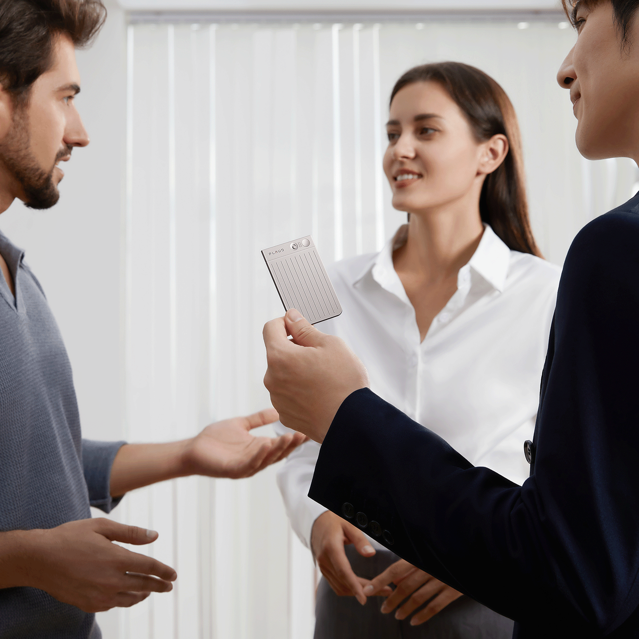 Plaud Note AI voice recorder in meeting, silver portable device for meeting recording and note taking