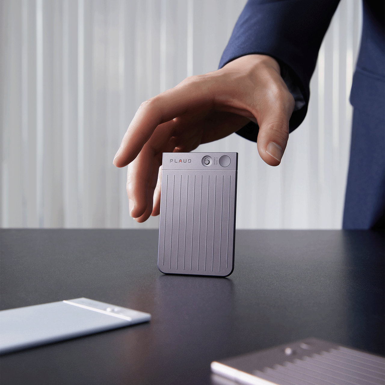 Professional-grade Plaud Note AI voice recorder with silver compact design for meeting transcription and call recording