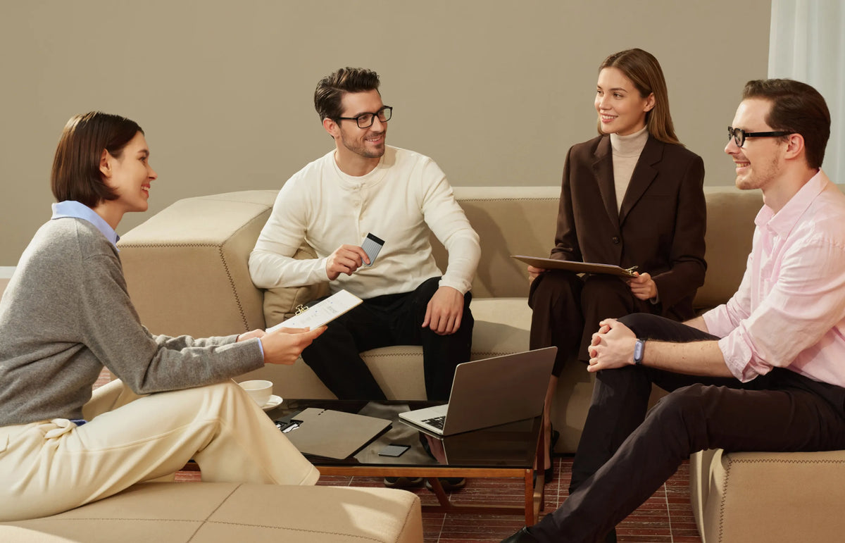 Professionals in a meeting using a black Plaud Note Pro.