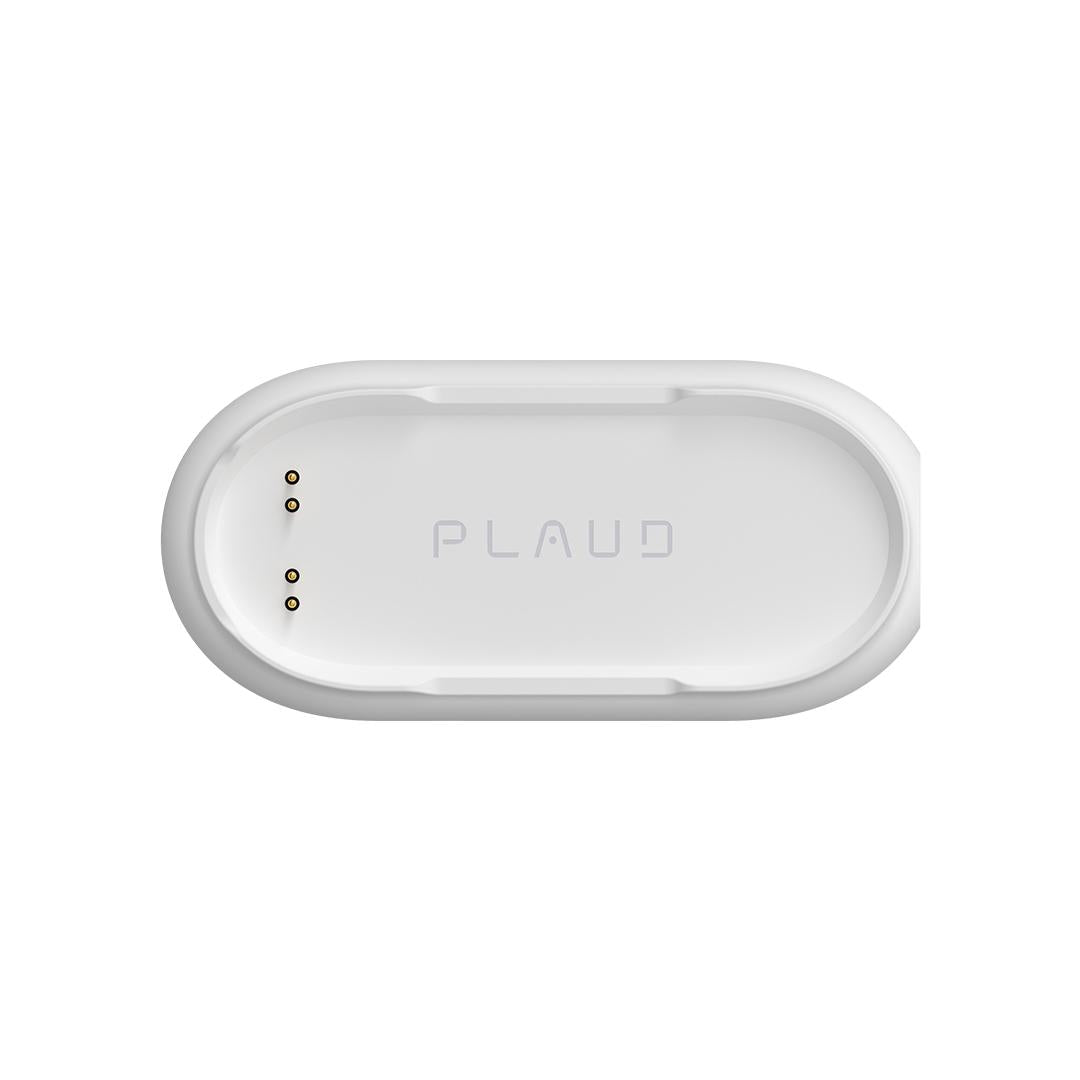White Plaud NotePin charging dock with oval design, embossed PLAUD logo, and metallic contact points for convenient wearable AI device charging