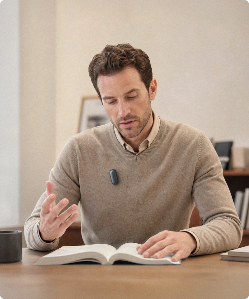 Educator wearing a black Plaud NotePin S via magnetic pin, recording the discussion so no detail is missed.