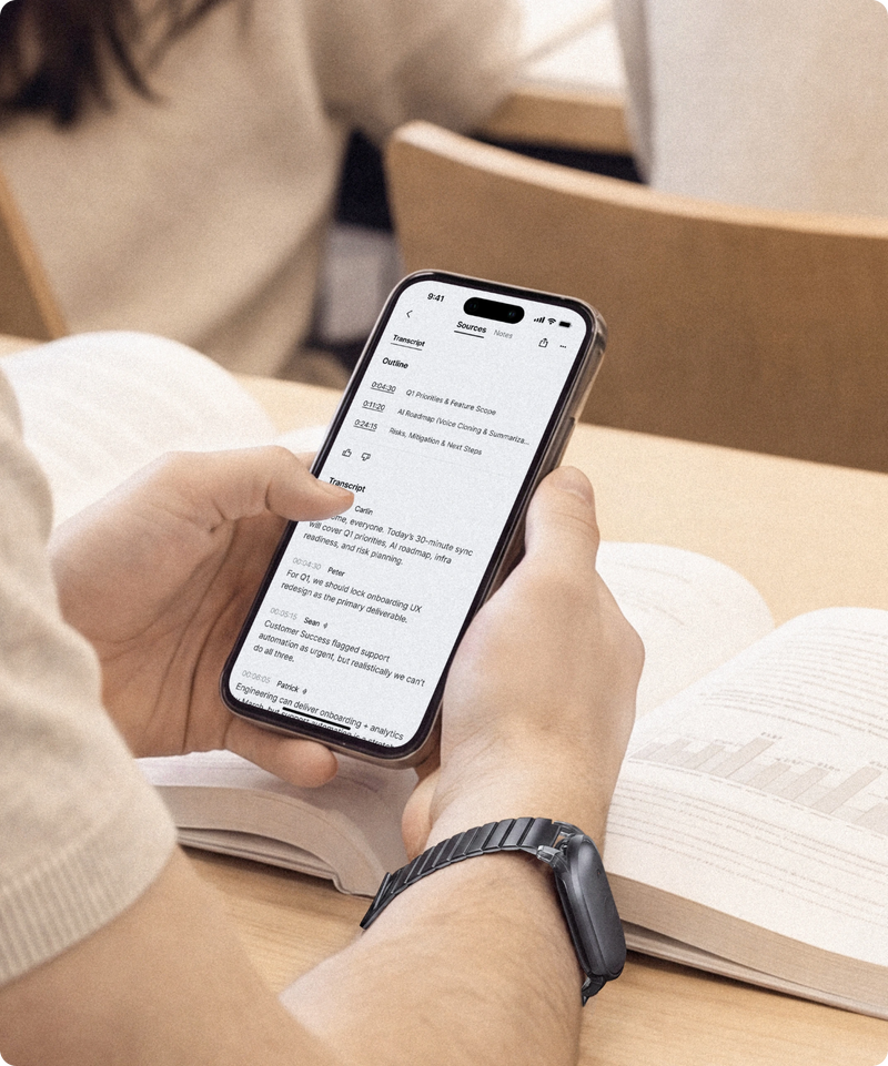 Student wearing a black Plaud NotePin S on a wristband, using the Plaud App to view the recording's transcript.