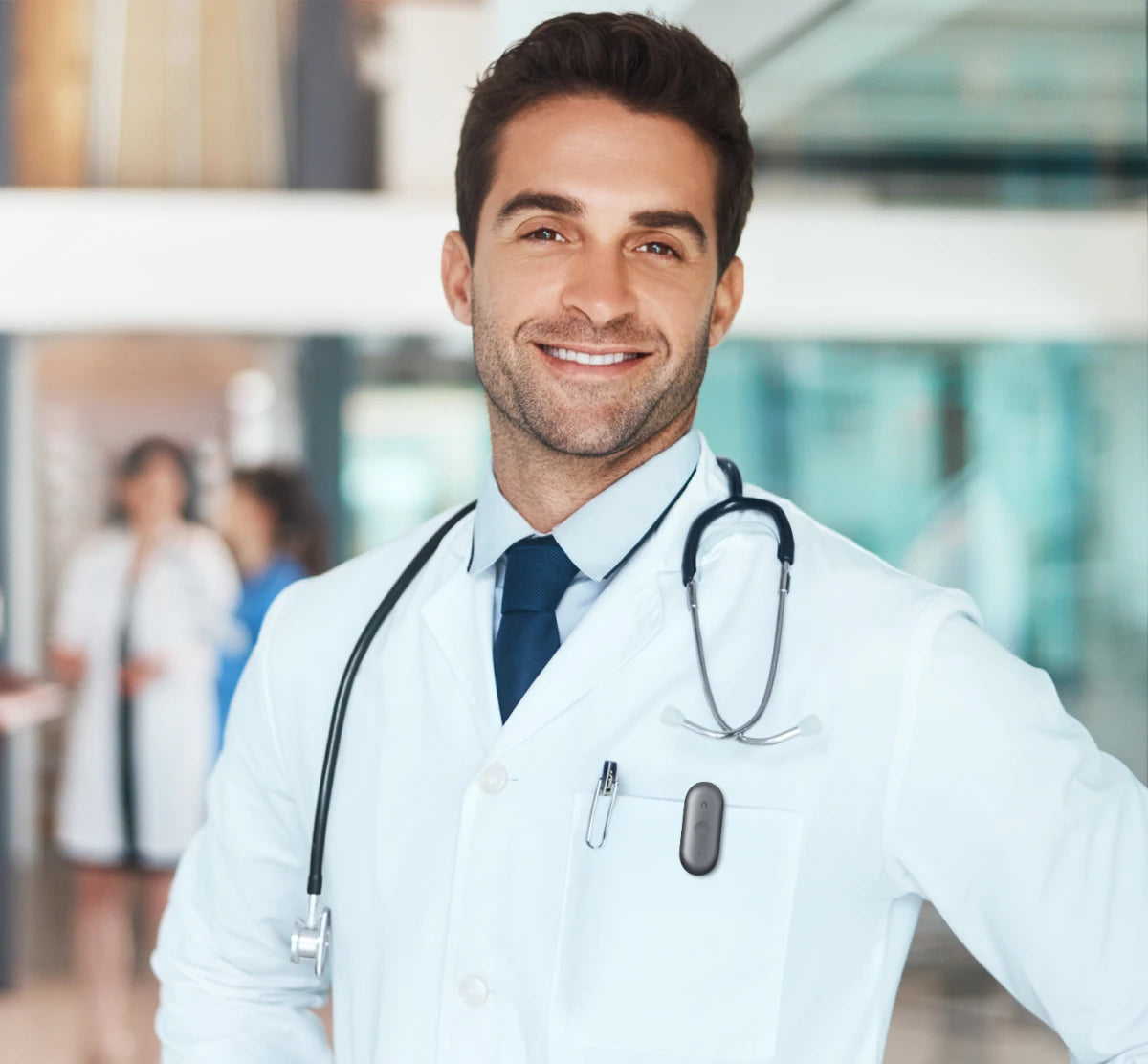 A clinician in a white coat with a Plaud NotePin S clipped to the coat pocket